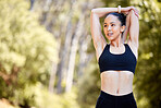 One fit young mixed race woman stretching arms for warmup to prevent injury while exercising outdoors. Hispanic athlete staying motivated and determined while mentally and physically preparing for training workout