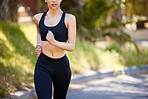 Closeup of one active mixed race woman running outdoors. Female athlete doing cardio workout while exercising for better health and fitness