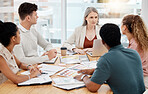Group of diverse businesspeople having a meeting in an office at work. Focused businesspeople talking during a workshop. Businesspeople planning together