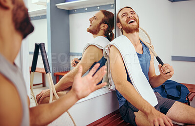 Buy stock photo Cheerful squash players laughing and talking. Two friends taking a break from their match to relax. Happy friends bonding in the gym locker room. Two men bonding before playing a game of squash