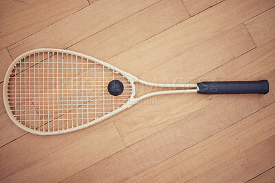 Buy stock photo Above view of squash gear equipment on wooden floor in empty court in sports centre with copyspace. Two rackets and ball arranged in sporty arena with nobody before championship game and competition