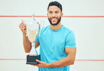 Portrait of squash player smiling and holding trophy after playing and winning court game with copyspace. Fit active hispanic athlete standing alone and feeling successful after championship challenge