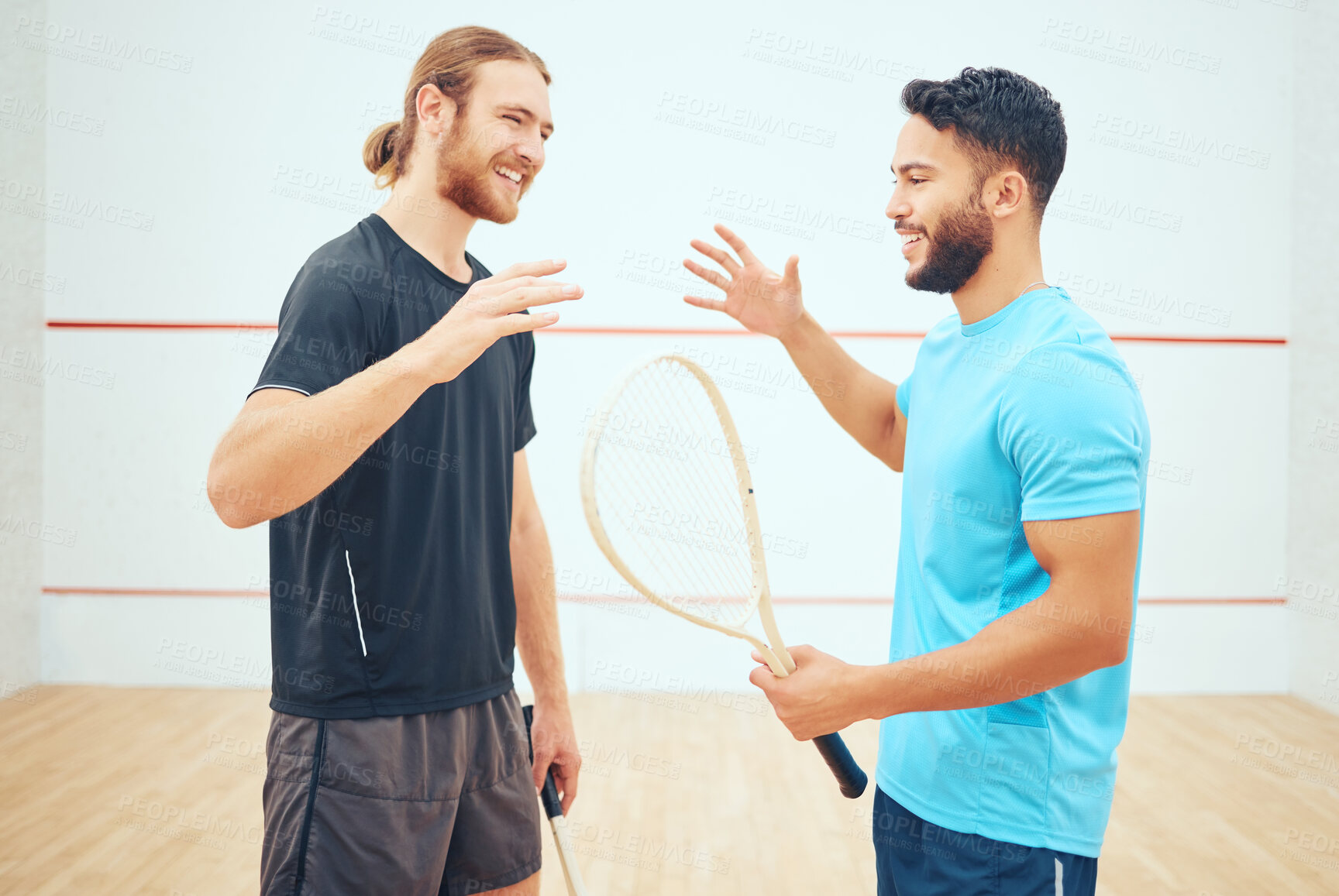 Buy stock photo Two athletic squash players shaking hands before court game. Team of happy fit active caucasian and mixed race male athletes using hand gesture before competing and training together in sports centre