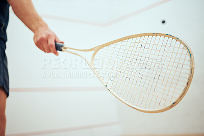 Buy stock photo Unknown athletic squash player using a racket to hit the ball during a game on the court. Fit active caucasian male athlete training and playing in a sports centre alone. Healthy cardio and sporty man