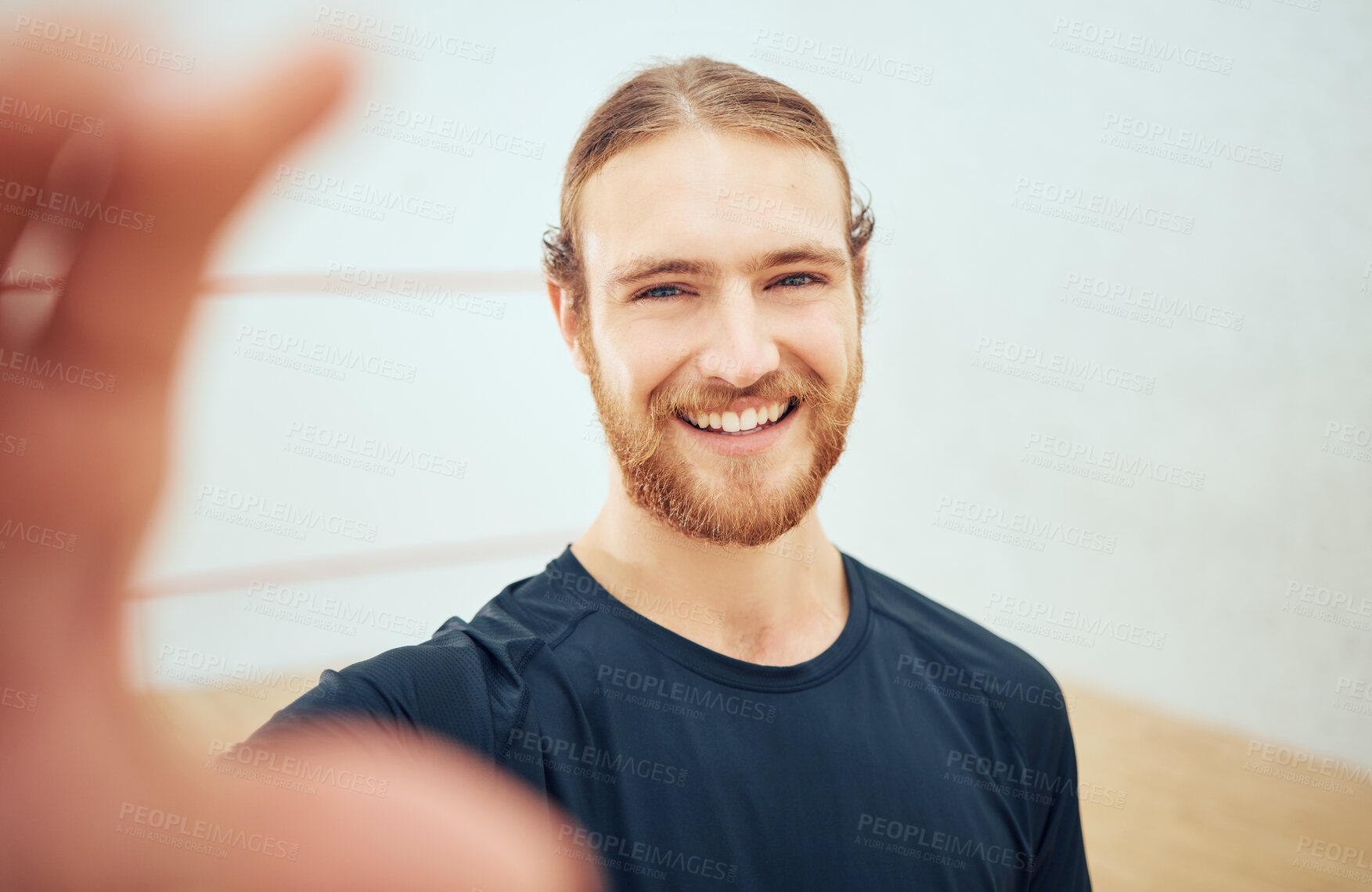 Buy stock photo Portrait of young athletic squash player taking selfie after playing court game with copyspace. Smiling fit active Caucasian athlete standing alone and feeling happy and taking social media picture