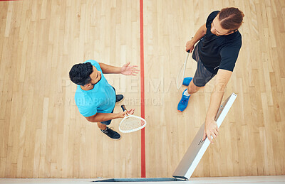 Buy stock photo Above view of two unknown squash players standing together after playing court game. Fit active mixed race and caucasian athletes talking after training practice in sports centre. Team of sporty men