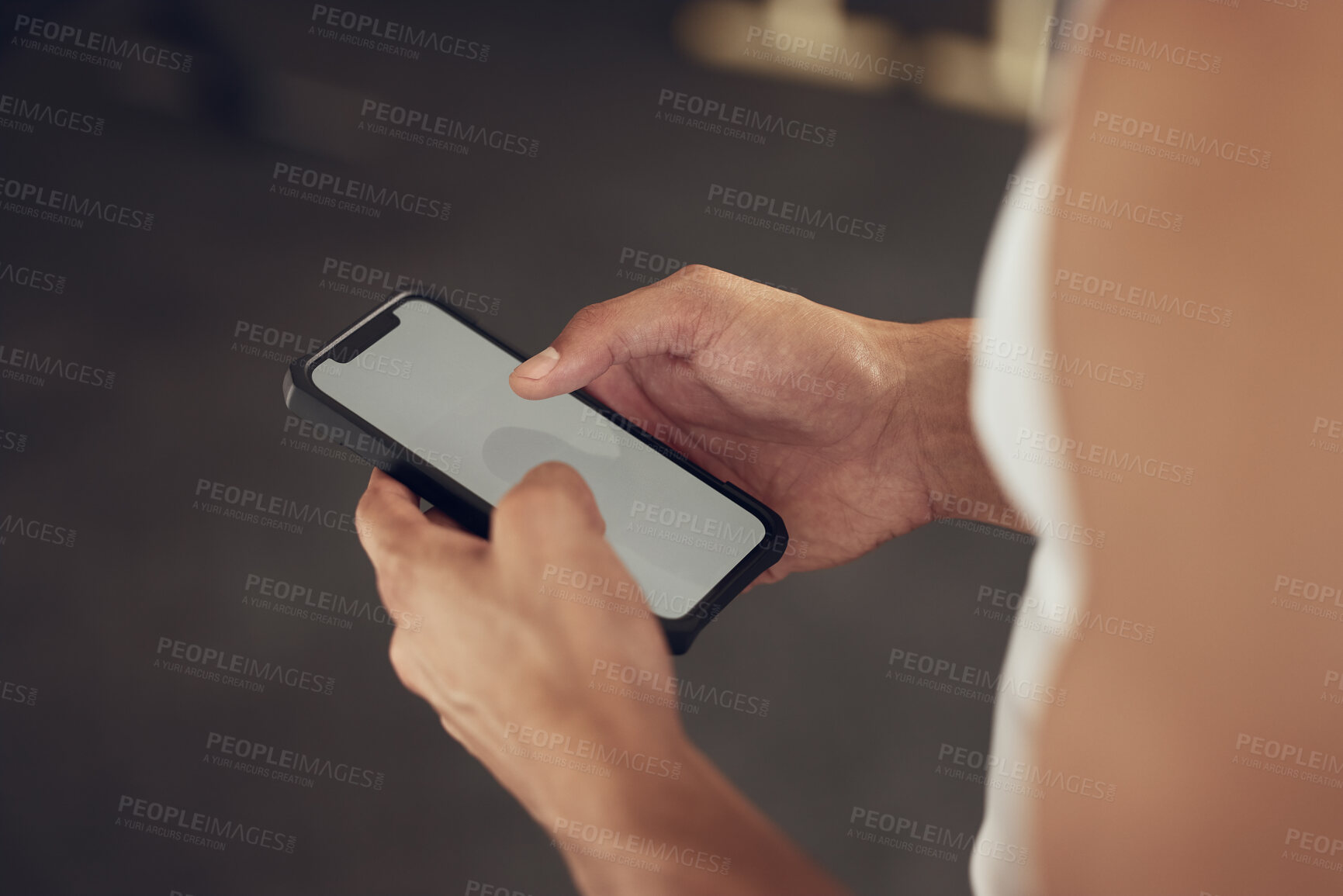 Buy stock photo Hands of a bodybuilder using their cellphone in the gym. Closeup on hands of an athlete using their smartphone. Screen of a mobile device being used in the gym. Athlete using online app on phone