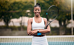 Portrait of a proud tennis player on the court. Young tennis player arms crossed standing on the court. Happy player holding her tennis racket. Young african american tennis player