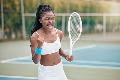 African american woman cheering after a tennis match. Young woman celebrating her success after a tennis match. Young girl playing a game of tennis on the court. Player holding a tennis racket