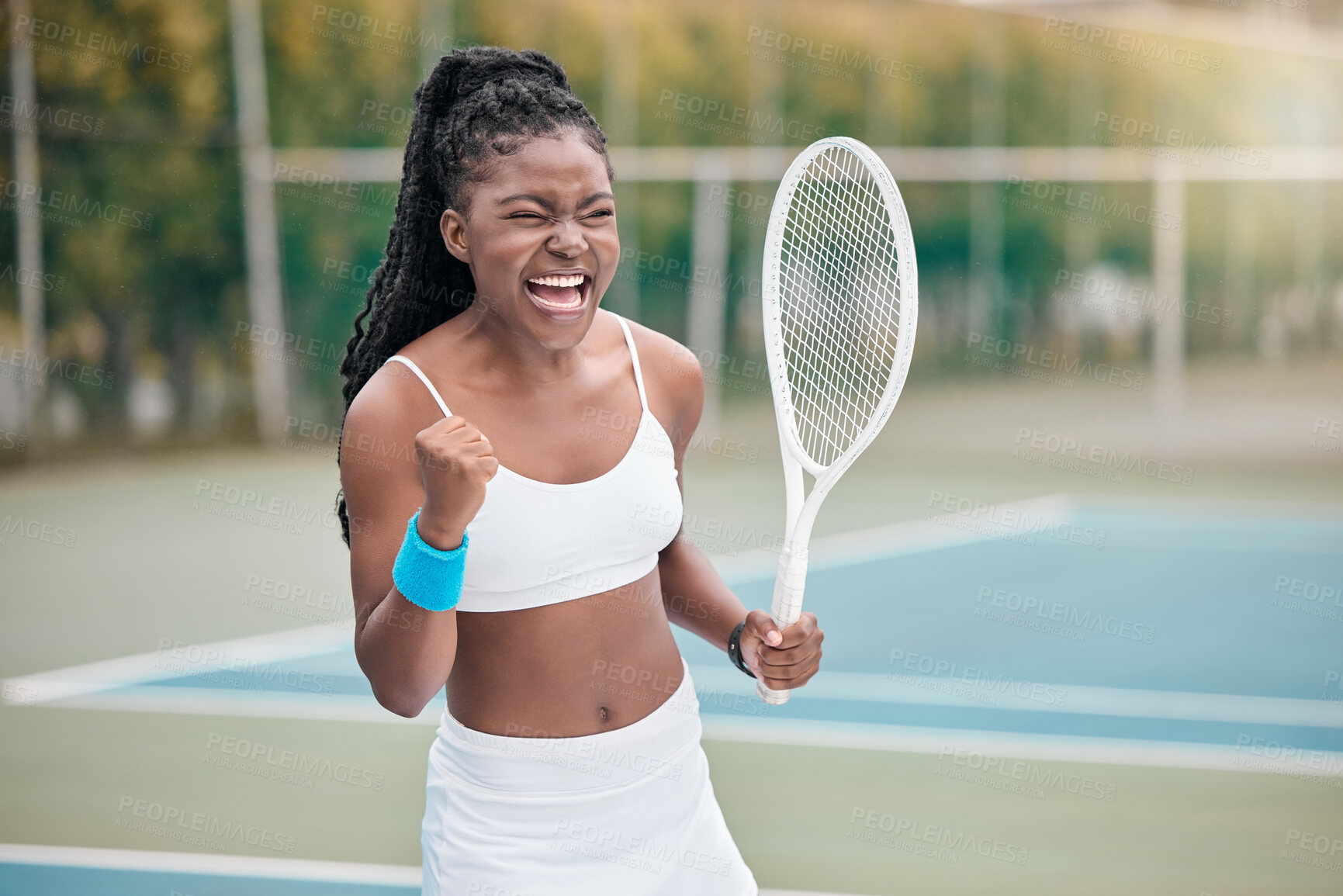 Buy stock photo African american woman cheering after a tennis match. Young woman celebrating her success after a tennis match. Young girl playing a game of tennis on the court. Player holding a tennis racket