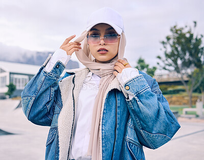 Buy stock photo Portrait, sunglasses or religion with a muslim woman outdoor in a cap and scarf for contemporary style. Islam, fashion or hijab with a trendy young arab female person posing outside in modern clothes
