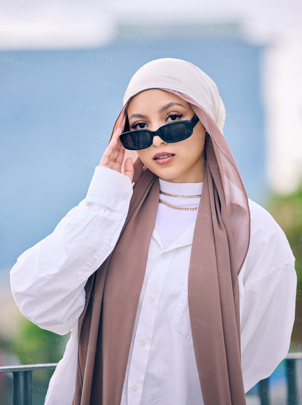 Buy stock photo Portrait, fashion or sunglasses with a muslim woman in dubai wearing a cap and scarf for contemporary style. Islamic, faith and hijab with a trendy young arab person posing outside in modern eyewear