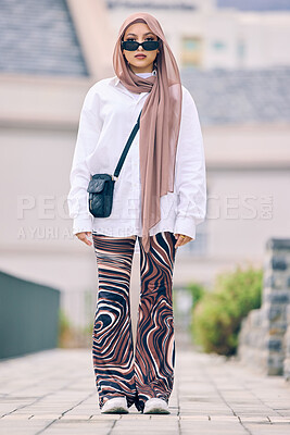 Buy stock photo Beautiful young arab woman posing outdoors in a headscarf. Attractive female muslim wearing a hijab posing outside. She's all about style and fashion. Mixed race woman looking confident and trendy