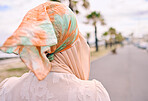 Rearview closeup arab woman posing outdoors in a headscarf. Unrecognizabe female muslim wearing a hijab while standing outside. She's all about style and fashion. Confident, trendy and stylish