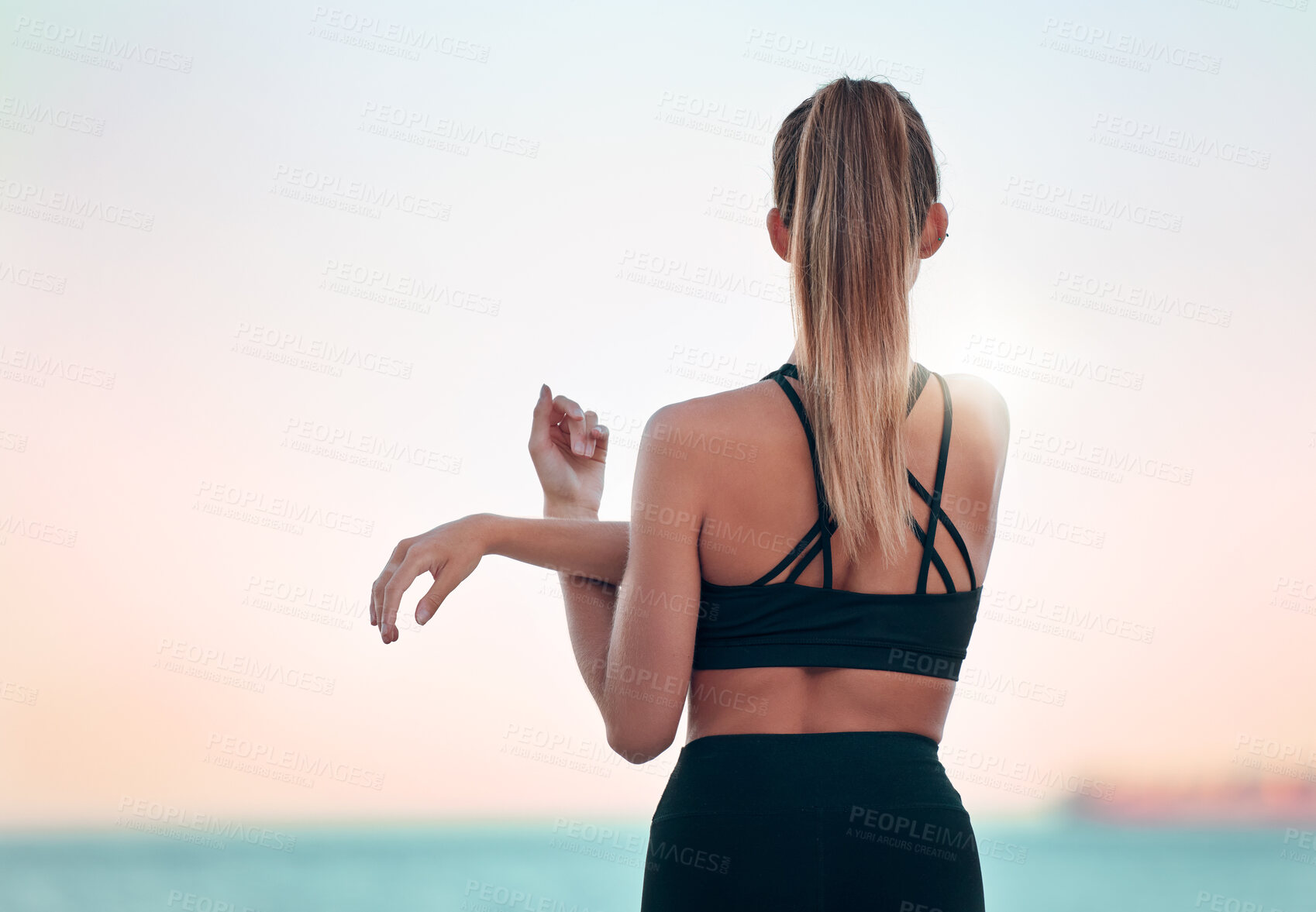 Buy stock photo Stretching arm, back and woman at beach for yoga, exercise and ocean mockup space. Fitness, pilates and female athlete stretch for training, workout and health, wellness or warm up at summer sunset.
