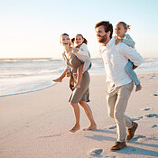 Young family bonding on the beach together. Happy parents having fun ...