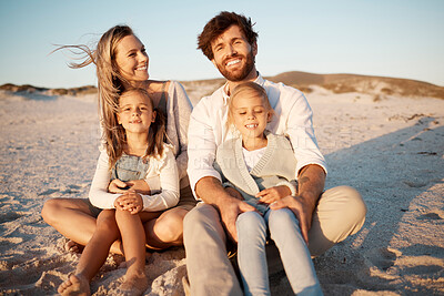 Buy stock photo Happy family relaxing on the beach together. Caucasian family bonding on the beach together. Parent on holiday with their children. Sisters relaxing with their parents. Family having fun on the beach