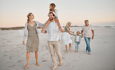 Buy stock photo Happy father carrying his daughter on the beach. family walking on the beach on holiday. Grandparents bonding with their grandchildren by the sea. Affectionate family strolling on the beach