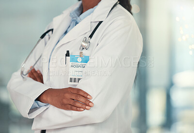Body of doctor in the hospital cropped. Confident doctor arms crossed in the hospital. African american doctor wearing a badge in the clinic. Closeup of caring doctor arms crossed