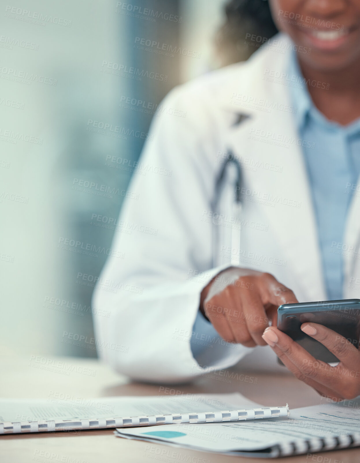 Buy stock photo Phone, doctor and hands of black woman texting for telehealth, healthcare or research in hospital. Smartphone, medical professional or happy person with online consultation, reading email or wellness