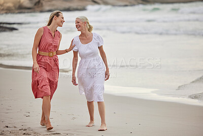 Buy stock photo A young caucasian woman spending the day at the beach with her elderly mother. White female and her mother smiling at the beach and hugging each other