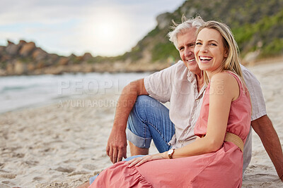 Buy stock photo Portrait of a senior caucasian man smiling and spending time with his daughter on vacation at the beach while sitting on the sand