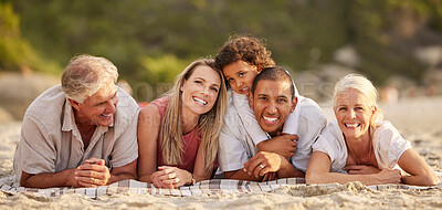 Buy stock photo Portrait of a senior caucasian couple at the beach with their children and grandchild. Mixed race family relaxing on the beach having fun and bonding