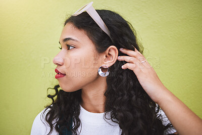 Buy stock photo Beautiful, young stylish and carefree African American black millennial woman. Long curly hair, with sunglasses on her head, standing against a lime background, looking pretty and bold 