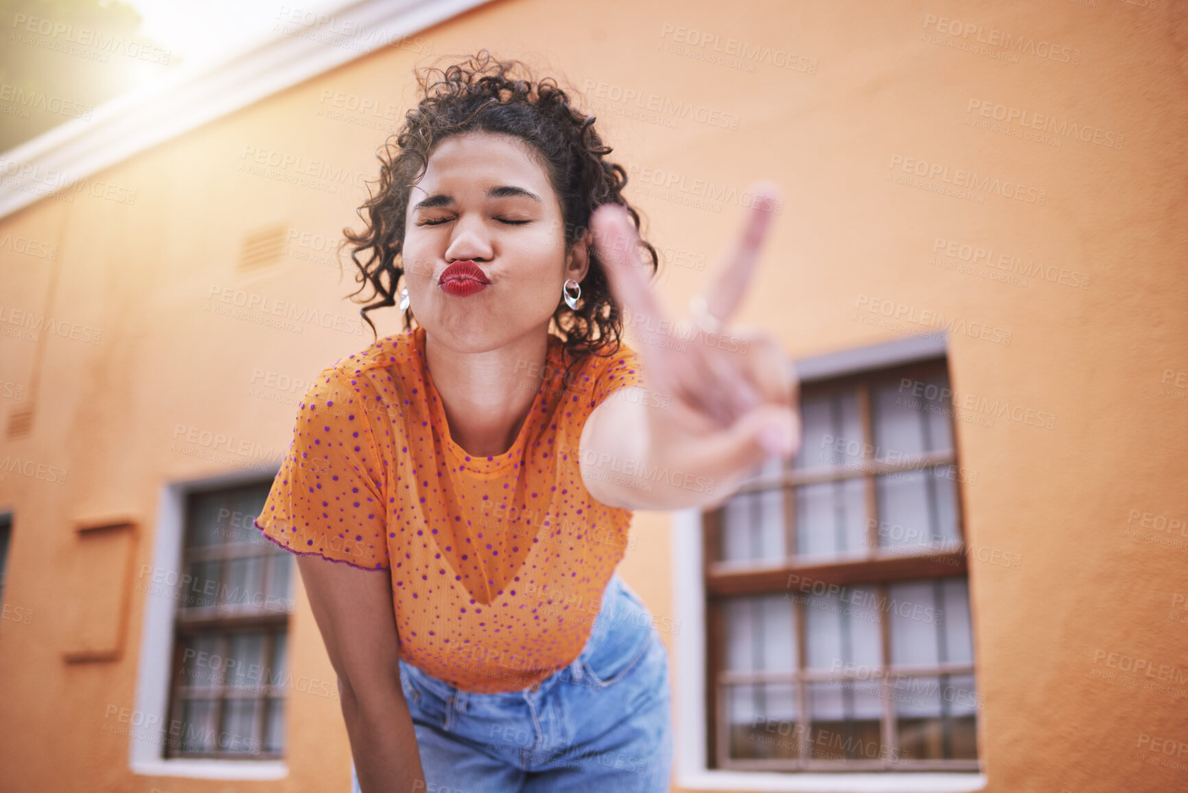 Buy stock photo Freedom, fun and hand peace sign by flirting black woman posing outdoors, relax and carefree. Love, positive and peaceful mindset by African American showing finger gesture and kiss in casual fashion