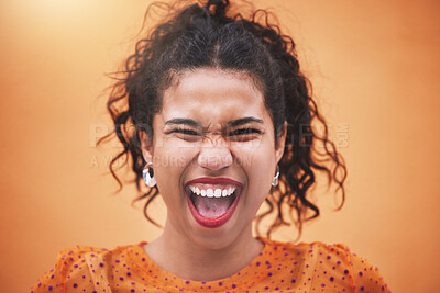 Closeup beautiful mixed race fashion woman smiling and laughing against an orange wall background in the city. Young hispanic woman looking stylish, trendy and happy. Fashionable and carefree