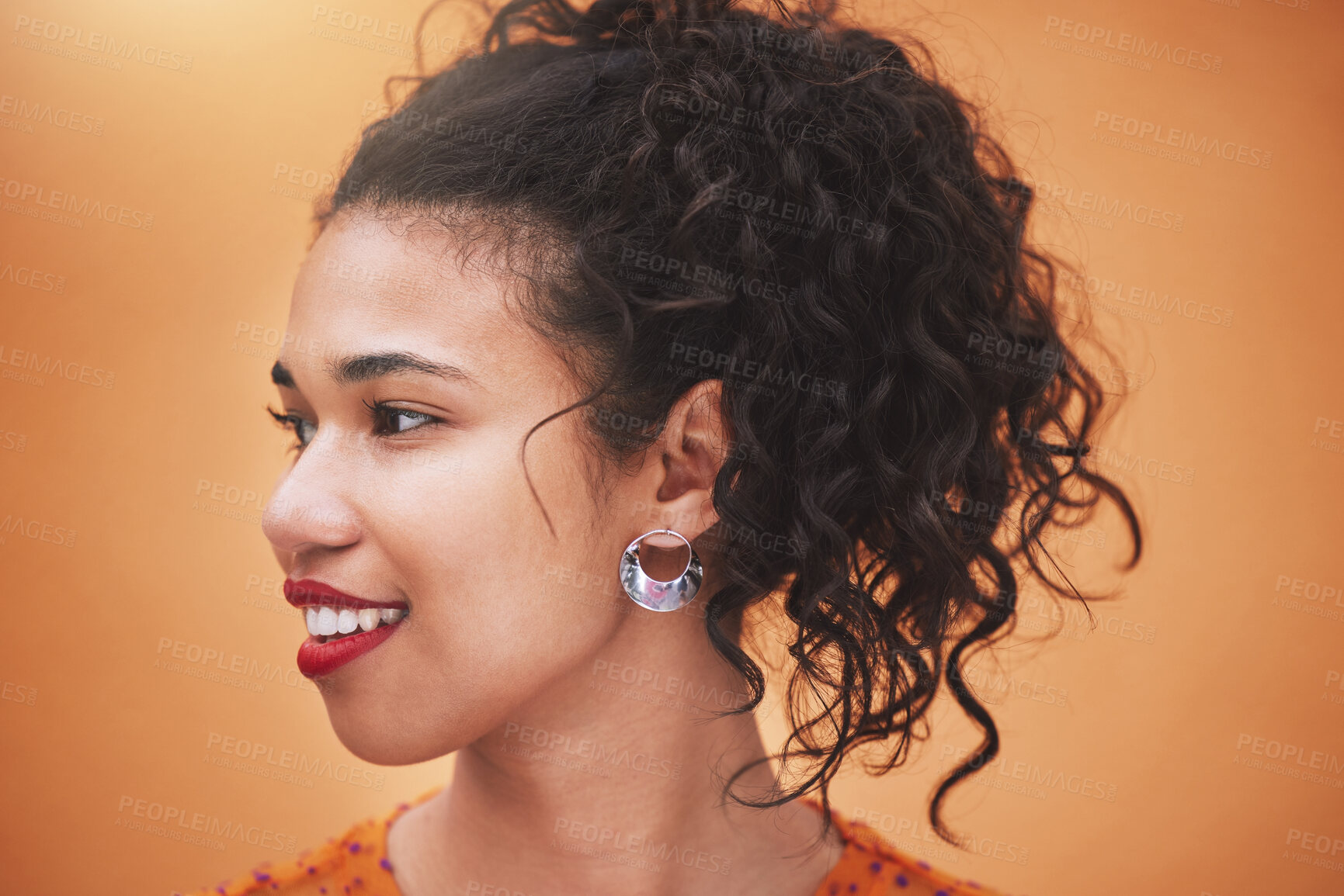 Buy stock photo Face of happy young hispanic woman thinking of ideas, beauty and gen z fashion against an orange color studio background. Smile, youth and happiness of confident girl with curly hair, vision and joy