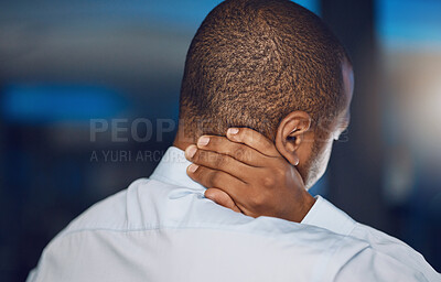 Above rearview young african man holding his neck in pain. African american business man suffering from the stress and pressure of deadlines which is causing anxiety, tension and stiff muscles