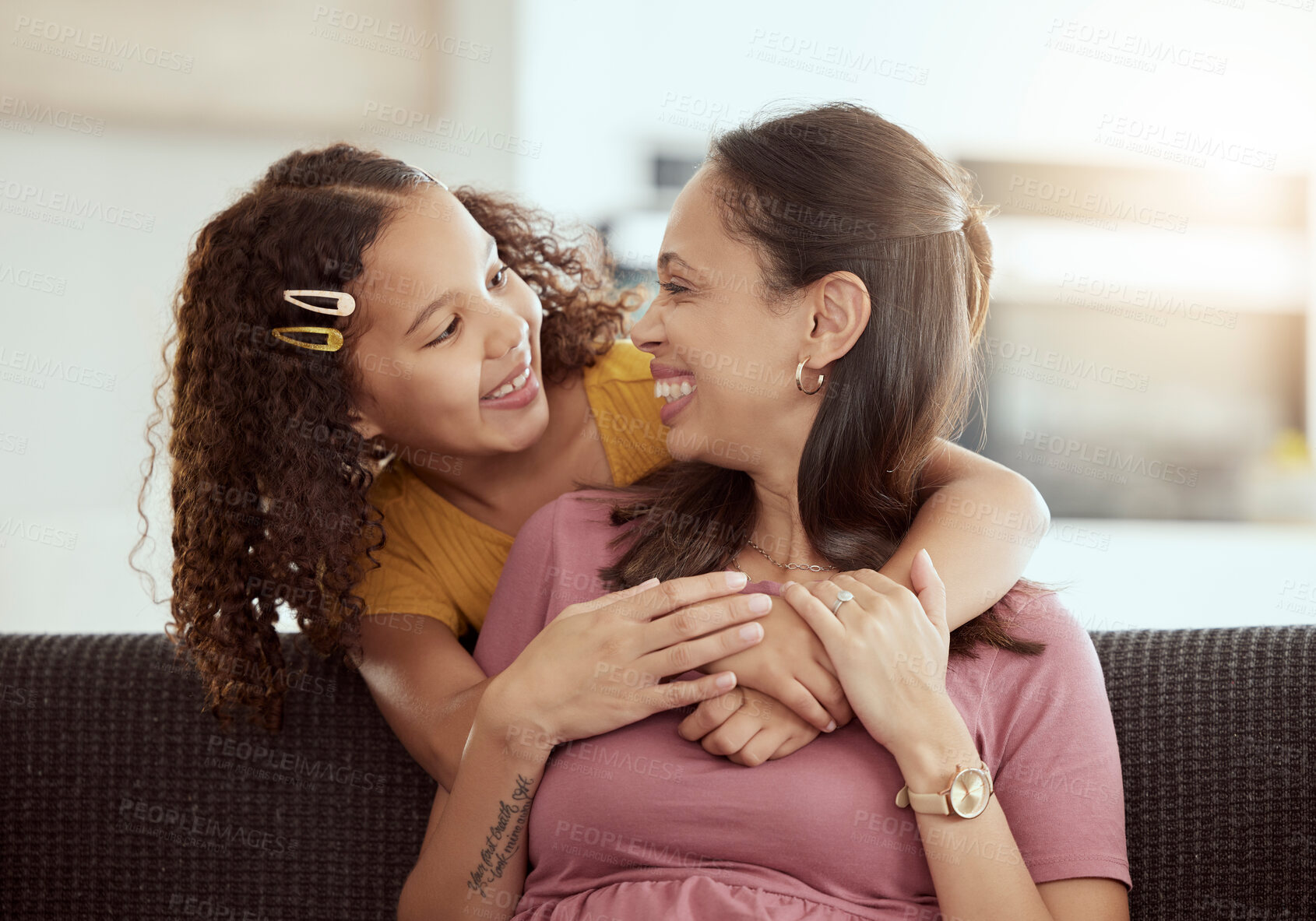 Buy stock photo Love, hug and mother with girl on a sofa, relax and happy in their home together, sweet and caring. Family, embrace and child with parent in living room, smile and hugging while having fun on weekend