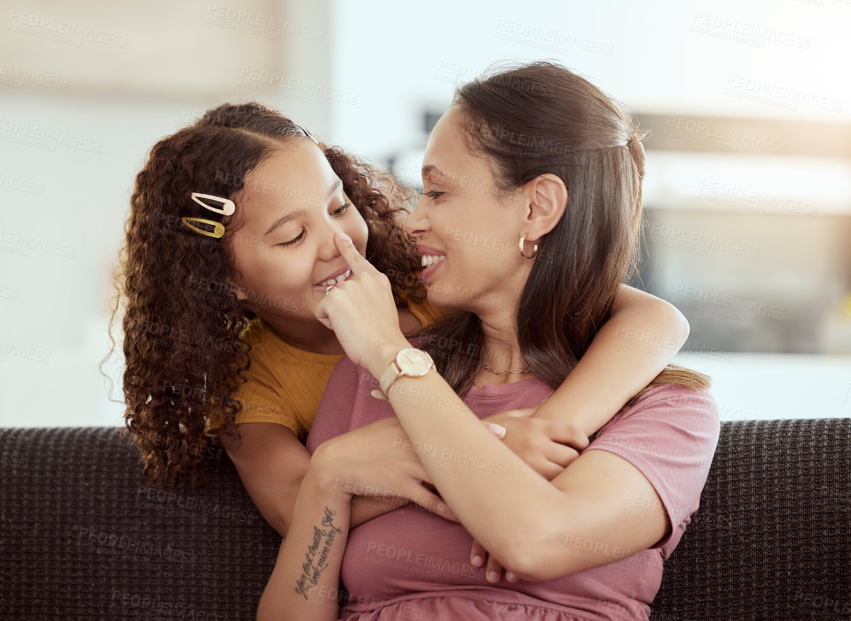Buy stock photo Hug, love and mother with girl on a sofa, playing and happy in their home together, sweet and care. Family, embrace and child with parent in living room, smile and hugging while having fun on weekend