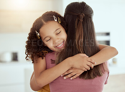 Buy stock photo Mixed race single mother and daughter hugging in living room at home. Smiling hispanic girl embracing single parent and bonding in lounge. Happy affectionate child and woman finding comfort on weekend