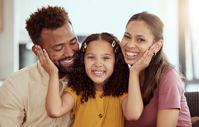 Mixed race parents enjoying weekend with daughter in home living room. Smiling hispanic girl hugging and bonding with mother and father in lounge. Happy affectionate couple sitting together with child