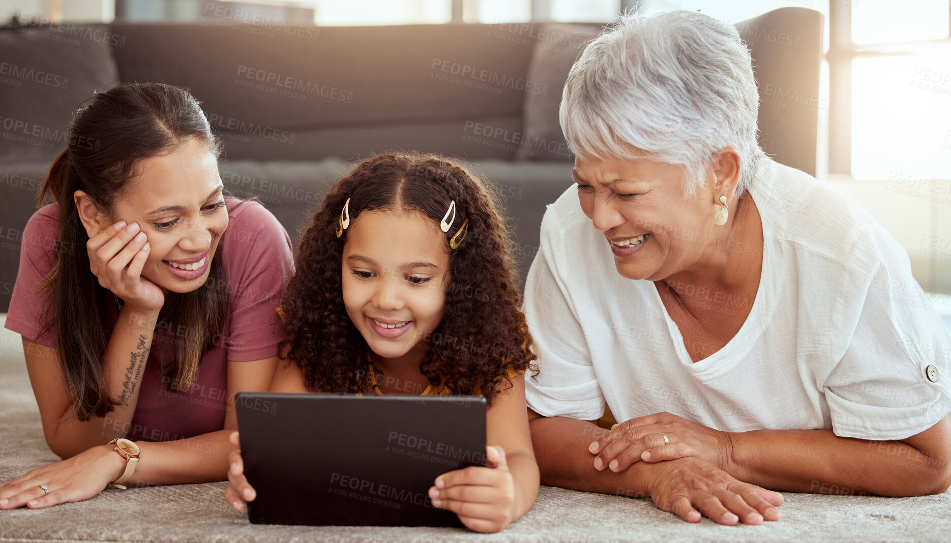 Buy stock photo Mother, girl and grandmother with tablet, floor and happy for meme, movie or social media app in living room. Mama, kid and senior woman with touchscreen with smile, reading or learning on internet