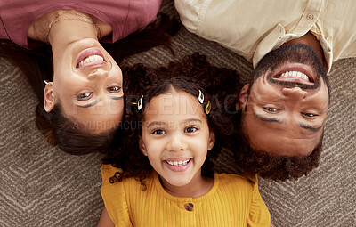 Buy stock photo Above portrait of mixed race parents enjoying weekend with daughter in home living room. Smiling hispanic girl hugging mother and father and bonding in lounge. Happy couple lying together with child