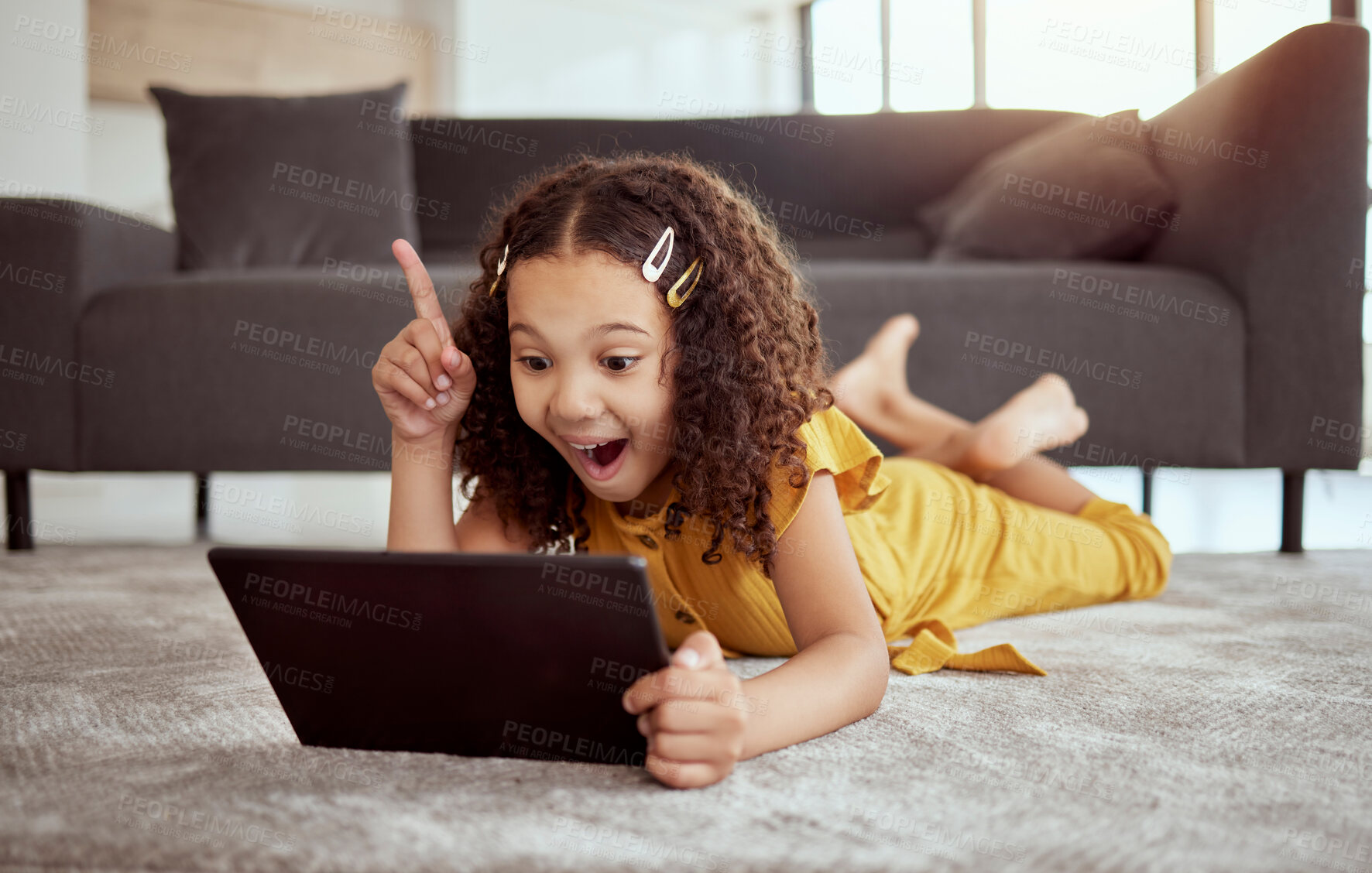 Buy stock photo Creative thinking, tablet learning and girl streaming education video on internet, planning idea with tech and excited about web app on living room floor. Kid with smile and solution to game online