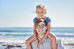 Portrait of happy caucasian father with glasses carrying his daughter on his shoulders at the beach on a sunny day. Loving dad and little girl spending time together while on holiday
