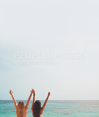 Buy stock photo Women, friends and sea with hands up by blue sky background, mockup space and outdoor with cheers. Girl, vacation and holiday for celebration, adventure and freedom by ocean, water or nature in Spain