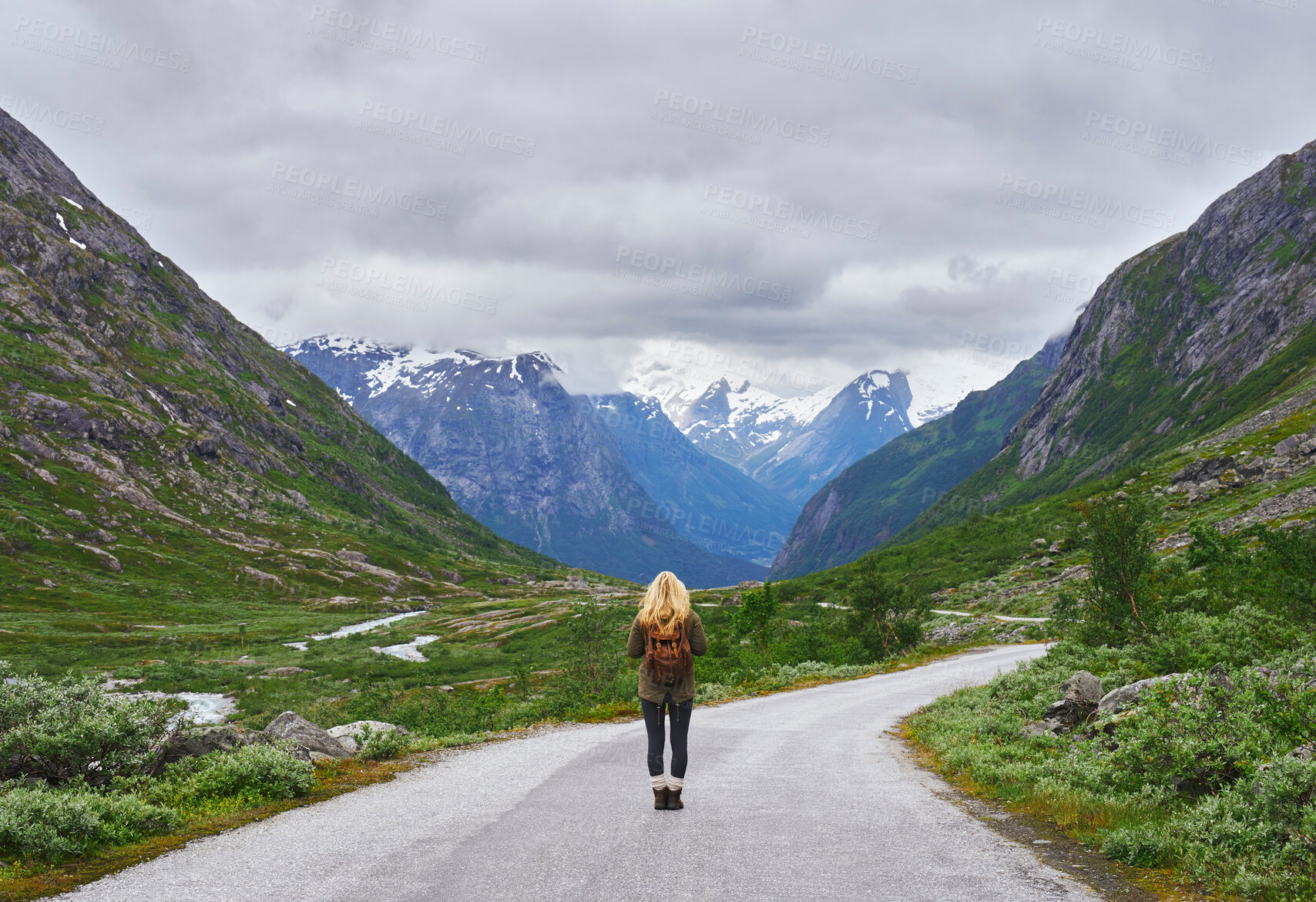 Buy stock photo Adventure backpacking woman travels on road in epic majestic mountain snow landscape