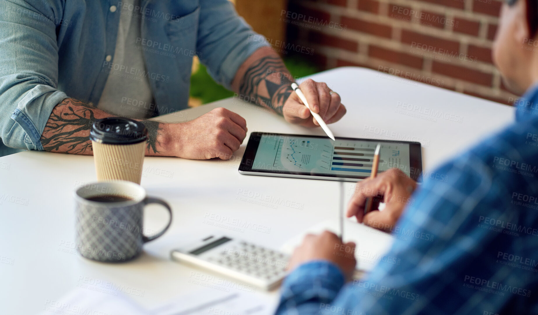 Buy stock photo two businessmen using tablet computer discussing financial graph data on mobile touchscreen device in meeting