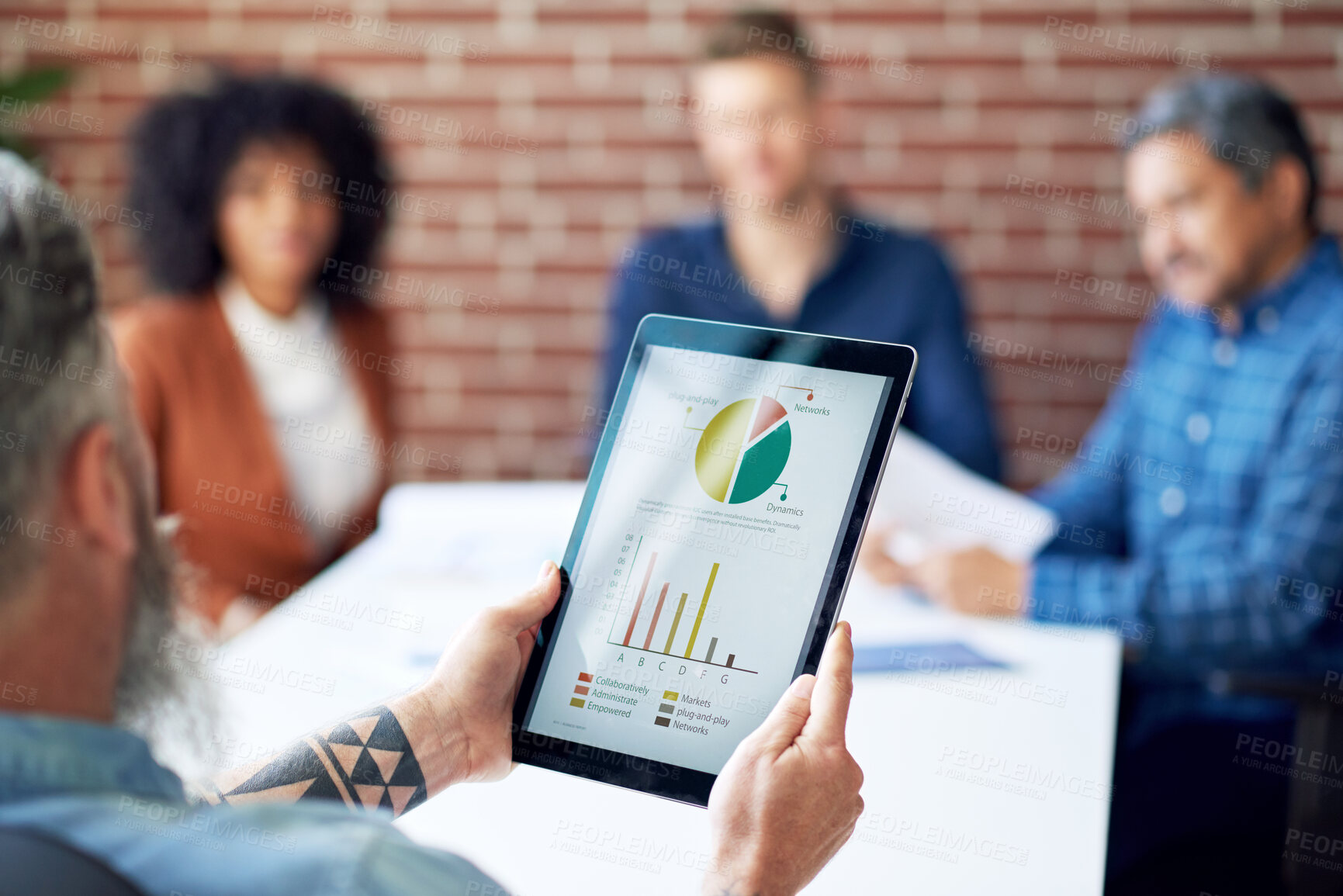 Buy stock photo businessman using digital tablet computer presenting financial graph data on screen discussing finance in office meeting with colleagues