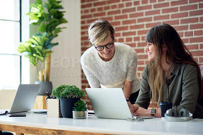 Buy stock photo two business women using laptop computer working in office team leader sharing ideas with colleague on screen
