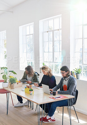 Buy stock photo College students sitting at table in class working on project