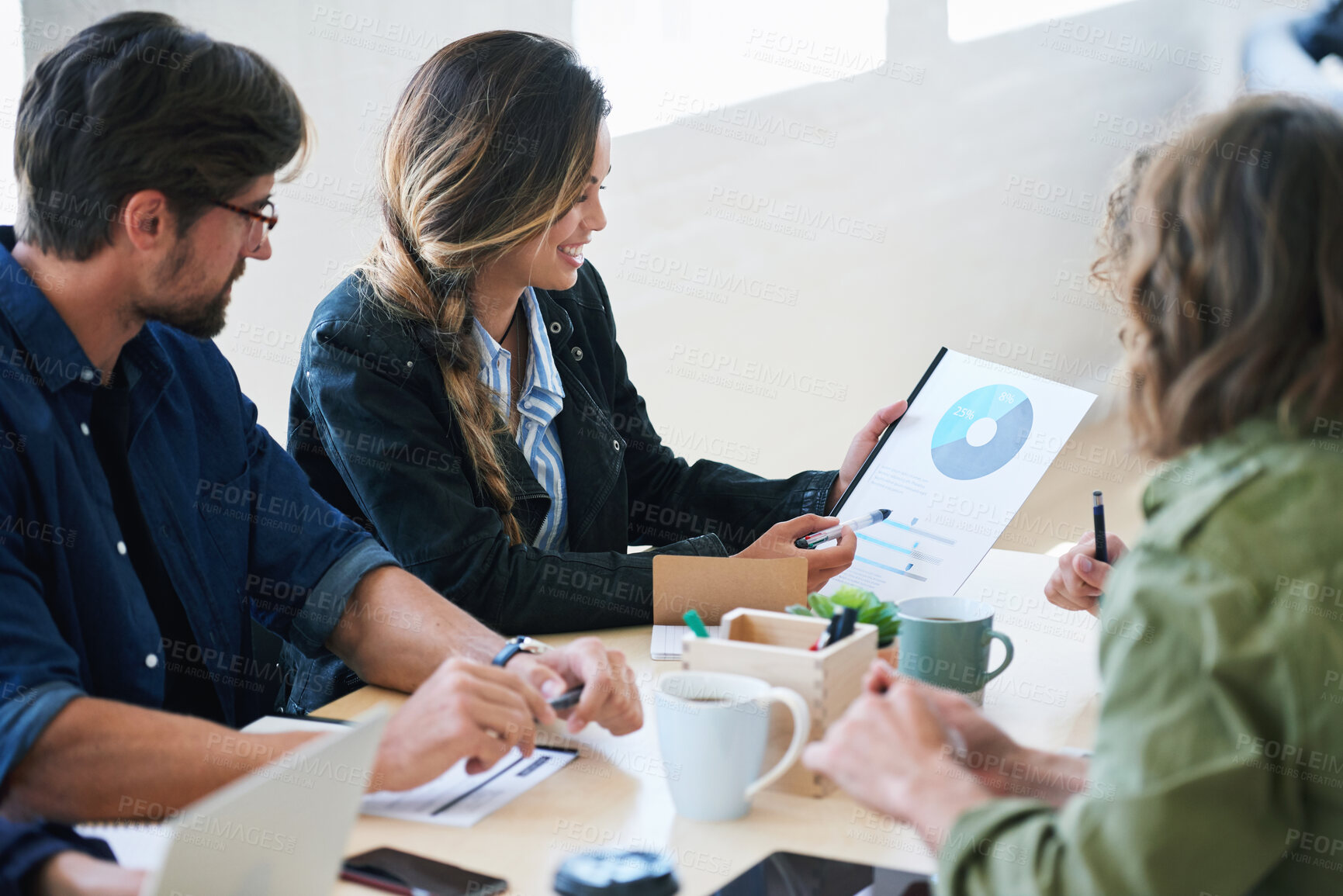 Buy stock photo Young business woman holding document presenting financial data to colleagues in meeting brainstorming ideas using market research