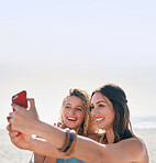 beautiful woman friends taking photo using smartphone camera on beach smiling happy sharing vacation on social media 