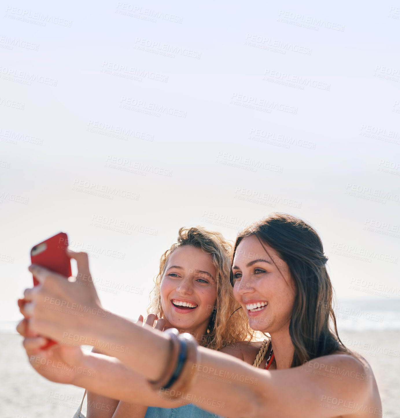 Buy stock photo beautiful woman friends taking photo using smartphone camera on beach smiling happy sharing vacation on social media