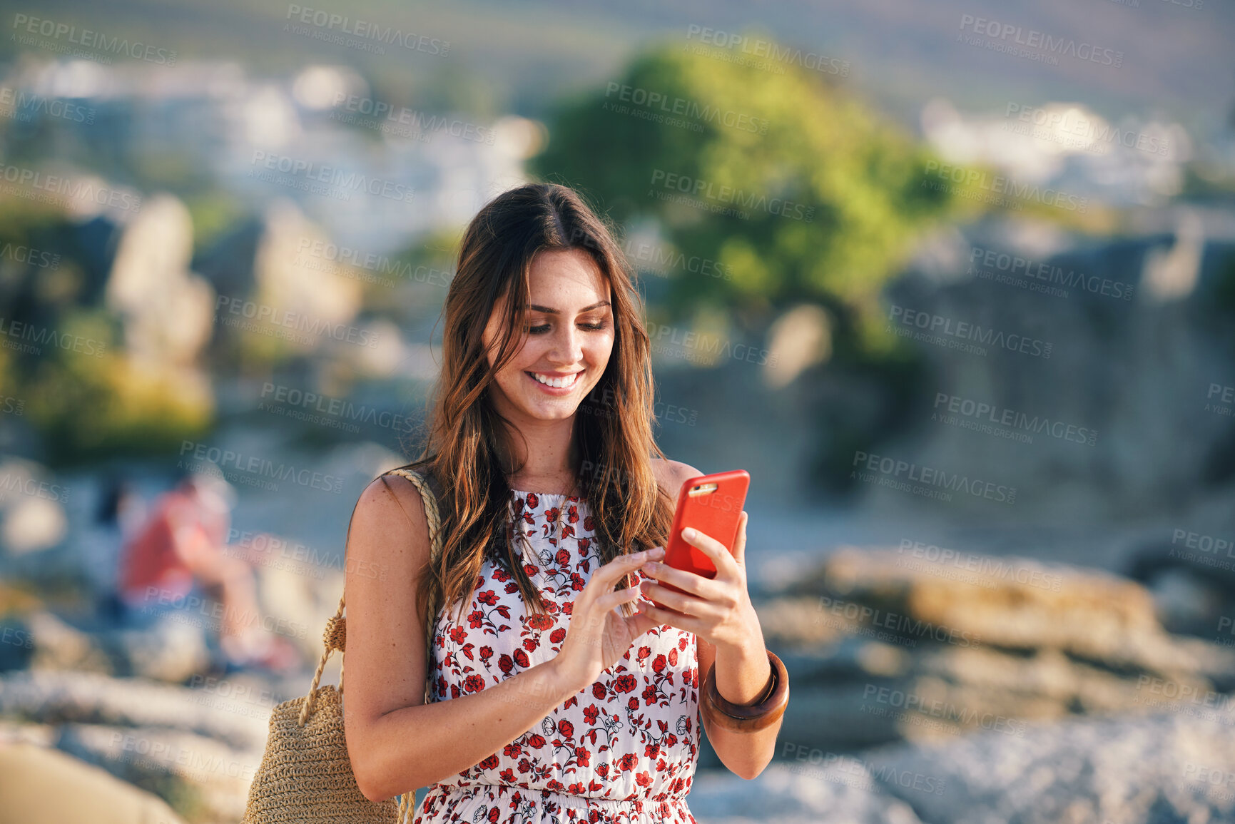 Buy stock photo Beautiful woman using smartphone texting on beach at sunset